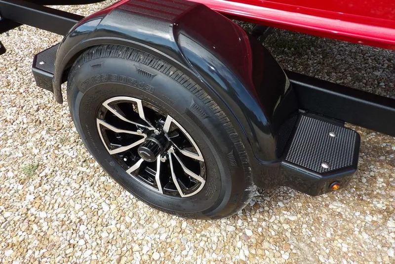 Slide: The Image of 2026 Lund 1775 Adventure Sport trailer wheel on gravel surface. - 42