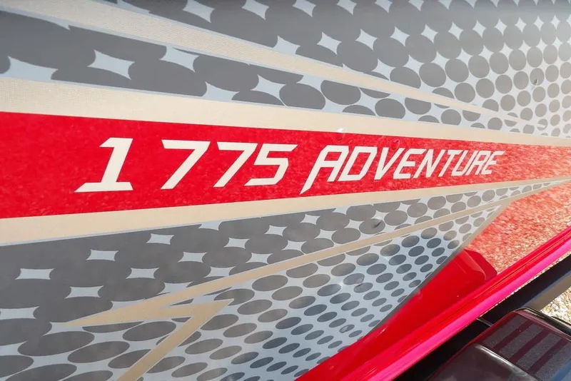 Slide: The Image of 2026 Lund 1775 Adventure Sport boat graphic with dynamic red and gray design. - 49