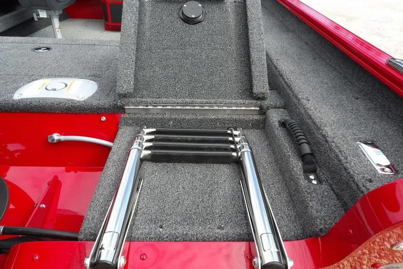 Slide: The Image of 2026 Lund 1775 Adventure Sport boat interior with foldable ladder and red accents. - 53