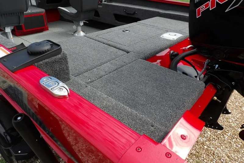 Slide: The Image of 2026 Lund 1775 Adventure Sport boat interior with gray carpet and red accents. - 7