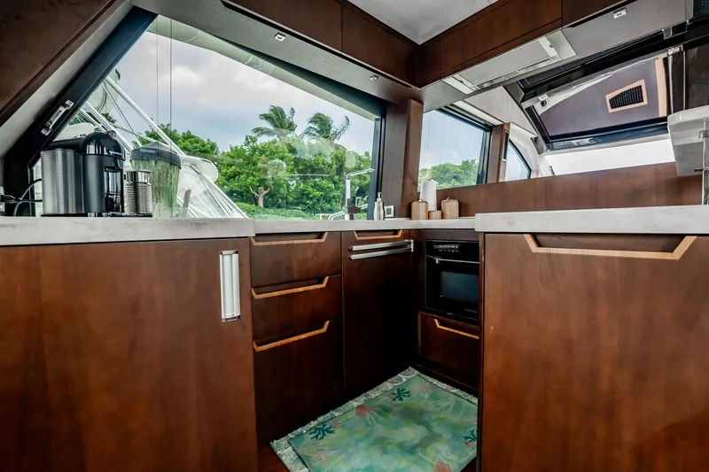 Slide: The Image of Luxurious kitchen interior of 2017 Galeon 510 Sky yacht with modern wood cabinetry. - 11