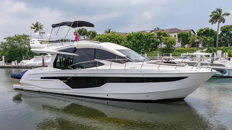 Slide: The Image of 2017 Galeon 510 Sky yacht docked in a serene marina setting. - 2