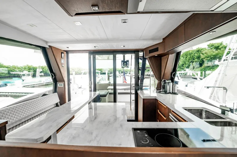 Slide: The Image of Luxurious interior of 2017 Galeon 510 Sky yacht with modern kitchen and scenic marina view. - 6