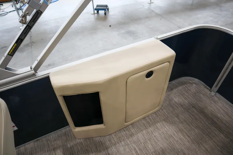 Slide: The Image of 2026 Godfrey Sweetwater 2286 C Tritoon interior detail with beige panel and carpeted floor. - 11