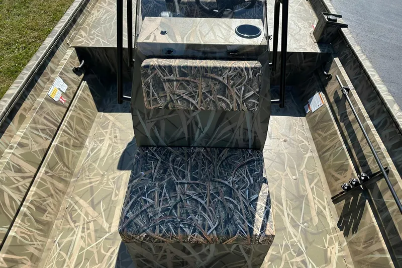 Slide: The Image of 2026 Lowe Roughneck 2070CC boat interior with camouflage seating and console. - 16