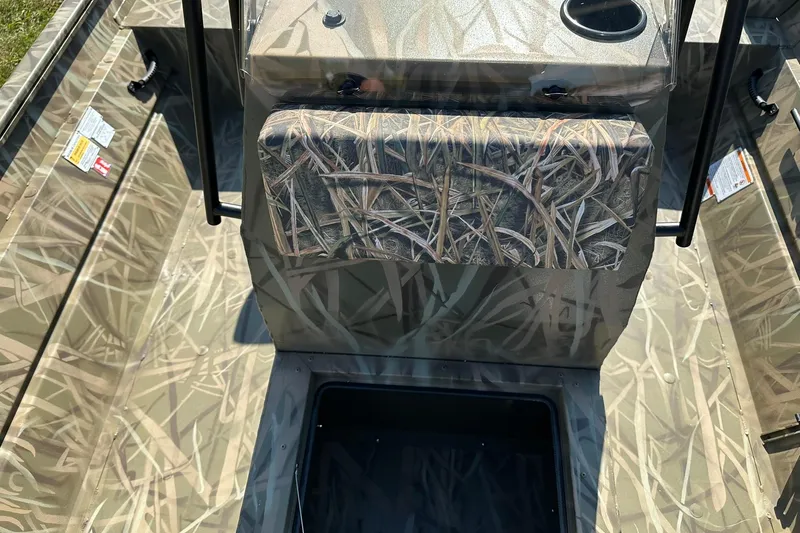 Slide: The Image of 2026 Lowe Roughneck 2070CC boat interior with camouflage design and storage compartment. - 17