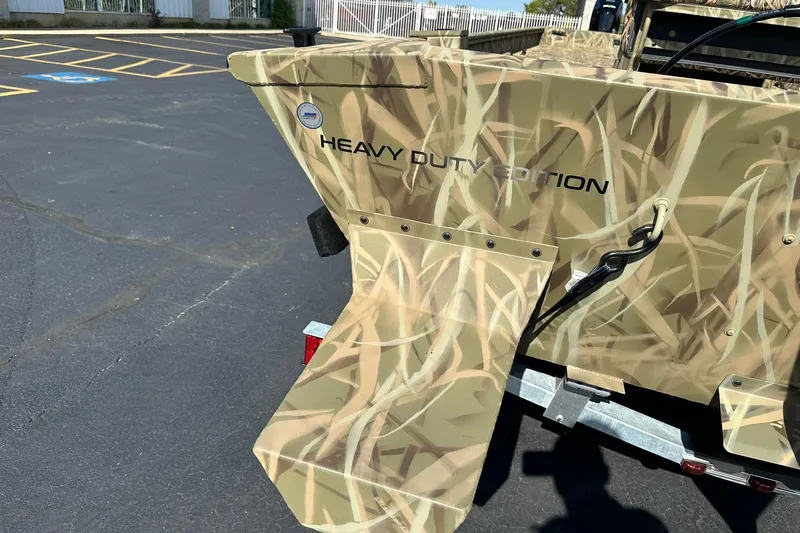 Slide: The Image of 2026 Lowe Roughneck 2070CC Heavy Duty Edition boat with camouflage design. - 21