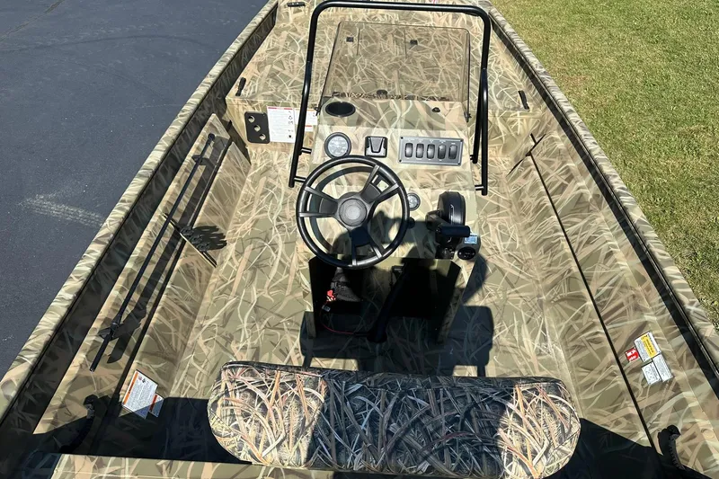 Slide: The Image of 2026 Lowe Roughneck 2070CC boat with camouflage interior and steering console. - 6