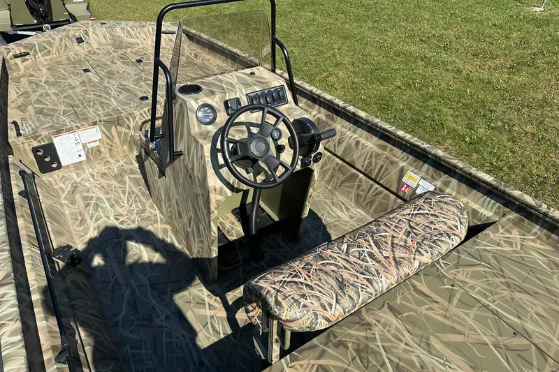 Slide: The Image of 2026 Lowe Roughneck 2070CC boat with camouflage design, featuring a central console and steering wheel. - 7