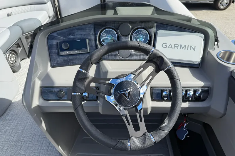 Slide: The Image of 2026 Tahoe Pontoon LTZ Versatile Rear Lounger dashboard with Garmin navigation system. - 11