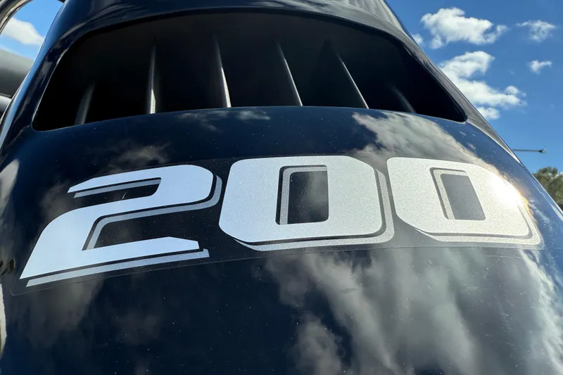 Slide: The Image of Close-up of a 200 horsepower engine on a 2026 Tahoe Pontoon LTZ Versatile Rear Lounger. - 19