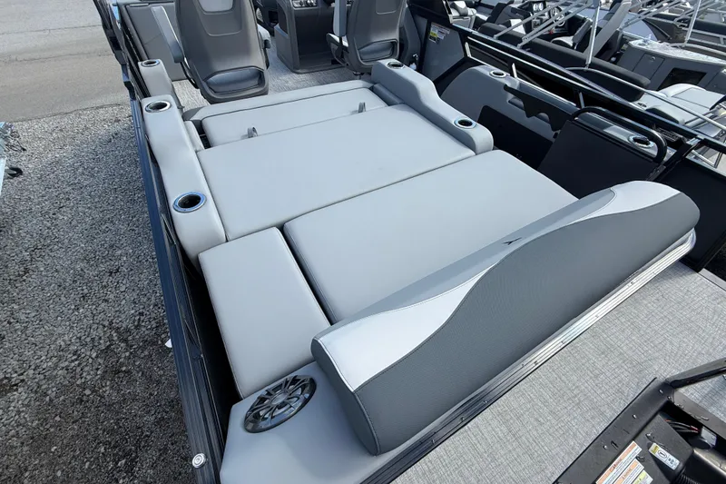 Slide: The Image of 2026 Tahoe Pontoon LTZ Versatile Rear Lounger with gray seating and cup holders. - 5