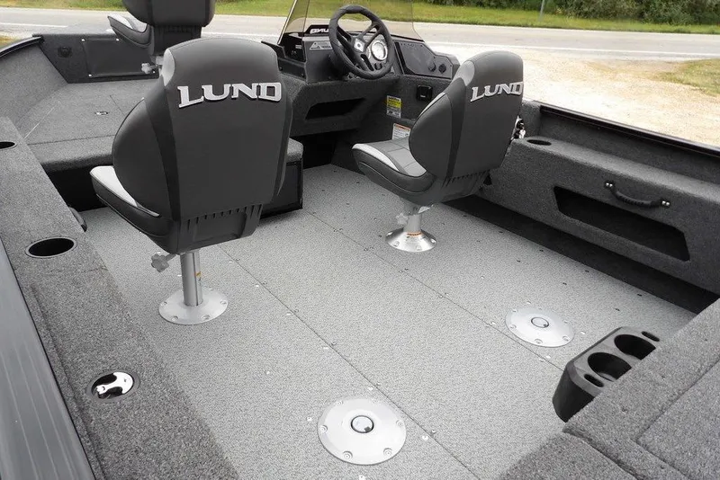 Slide: The Image of 2026 Lund 1775 Adventure SS boat interior with gray seating and carpeted flooring. - 11