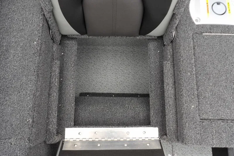 Slide: The Image of Interior view of 2026 Lund 1775 Adventure SS boat, featuring carpeted flooring and seating. - 12