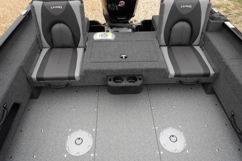 Slide: The Image of 2026 Lund 1775 Adventure SS boat interior with gray seating and storage compartments. - 13