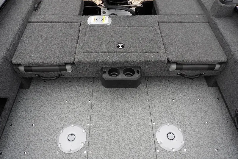 Slide: The Image of 2026 Lund 1775 Adventure SS boat interior with gray carpet and storage compartments. - 14