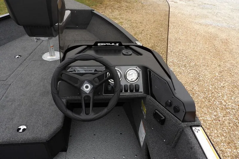 Slide: The Image of 2026 Lund 1775 Adventure SS boat dashboard with steering wheel and gauges. - 16