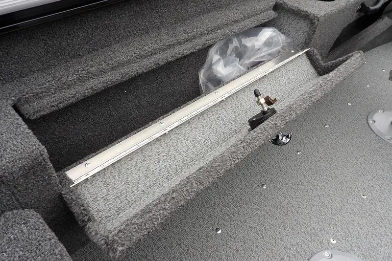 Slide: The Image of 2026 Lund 1775 Adventure SS boat interior storage compartment with gray carpeted finish. - 18