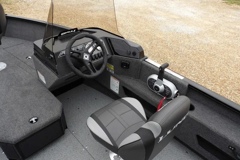 Slide: The Image of 2026 Lund 1775 Adventure SS boat interior with steering wheel and control panel. - 19