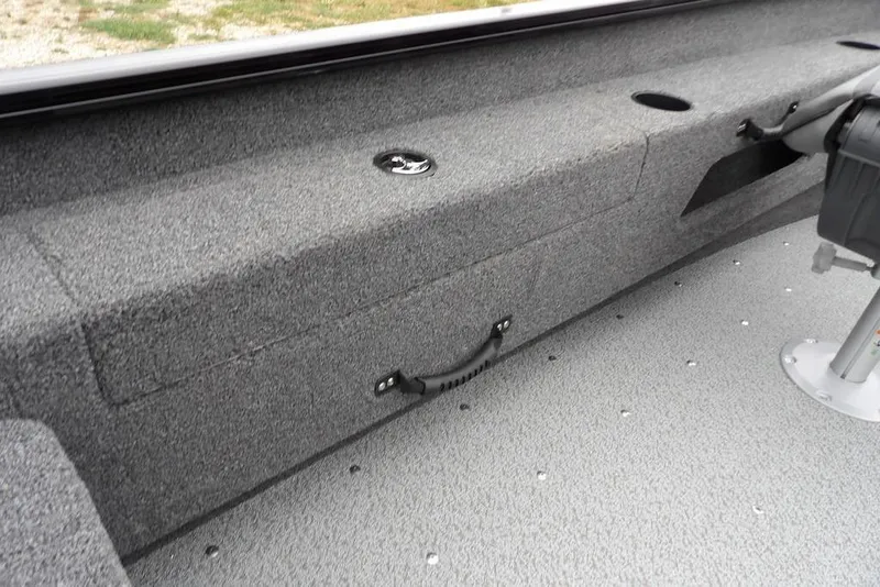 Slide: The Image of 2026 Lund 1775 Adventure SS boat interior with gray carpet and seating area. - 20