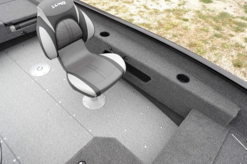 Slide: The Image of 2026 Lund 1775 Adventure SS boat interior with gray seating and carpeted flooring. - 22