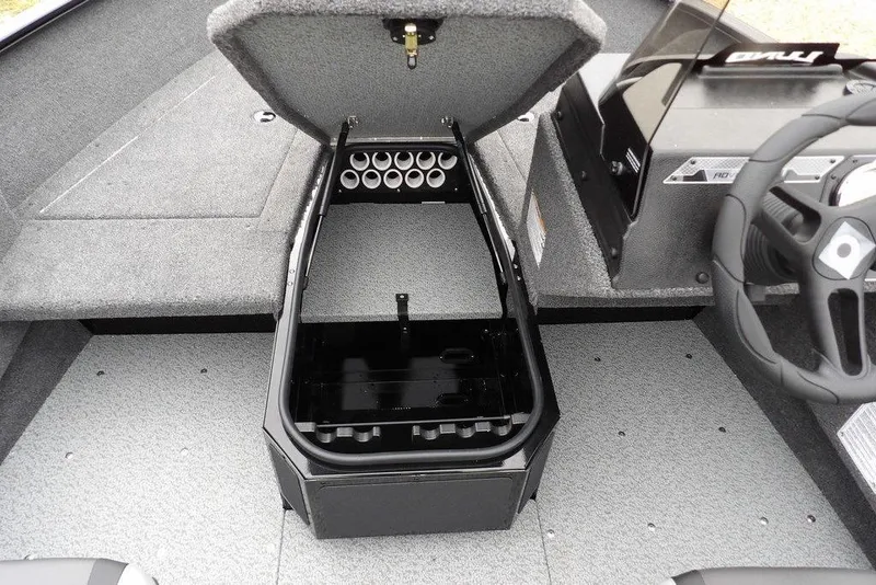 Slide: The Image of 2026 Lund 1775 Adventure SS boat interior with open storage compartment and steering wheel. - 27