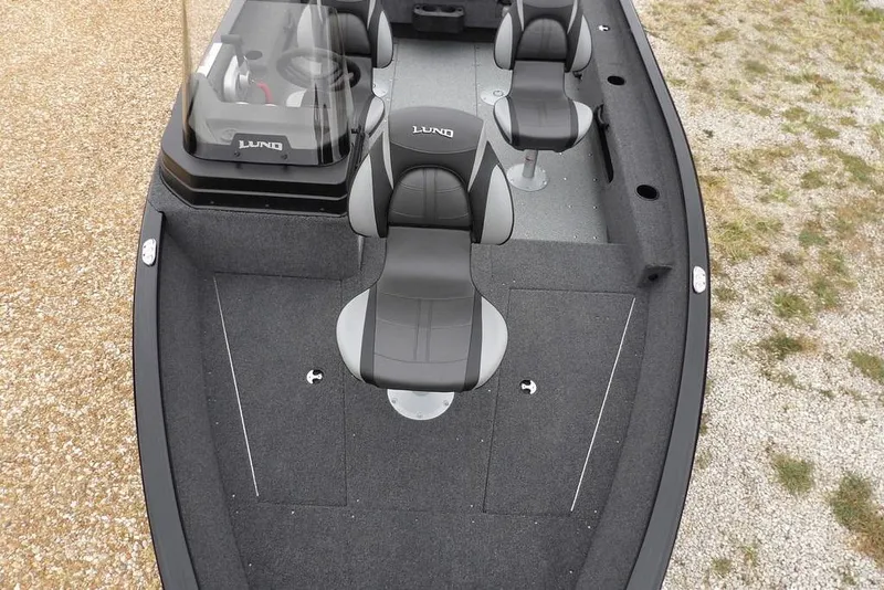 Slide: The Image of 2026 Lund 1775 Adventure SS boat interior with gray seating and steering console. - 29