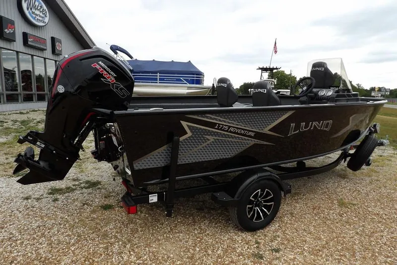 Slide: The Image of 2026 Lund 1775 Adventure SS boat with Mercury Pro XS engine at a marine center. - 3
