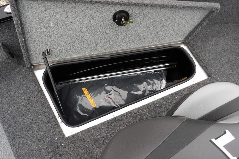 Slide: The Image of 2026 Lund 1775 Adventure SS boat storage compartment with open lid, showcasing interior space. - 30