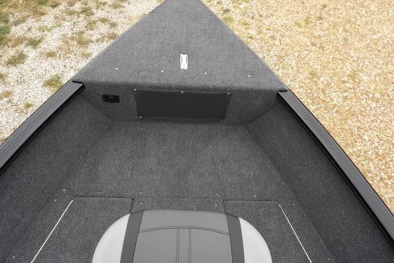 Slide: The Image of 2026 Lund 1775 Adventure SS boat interior with gray carpet and seating. - 32