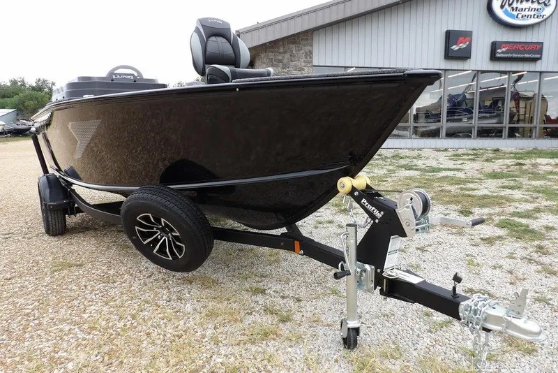 Slide: The Image of 2026 Lund 1775 Adventure SS boat on trailer outside marine center. - 33