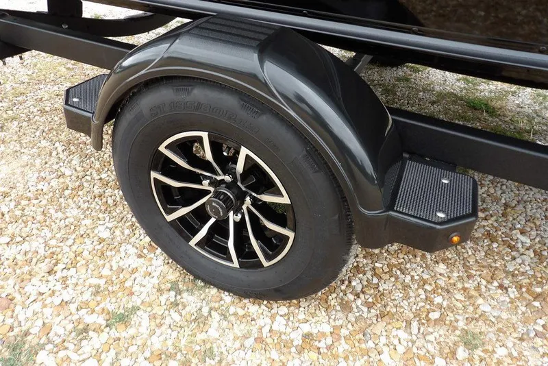 Slide: The Image of 2026 Lund 1775 Adventure SS trailer wheel on gravel surface. - 38