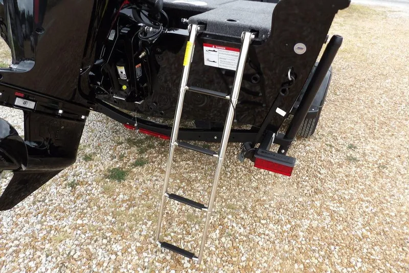 Slide: The Image of 2026 Lund 1775 Adventure SS boat with ladder on gravel surface. - 39