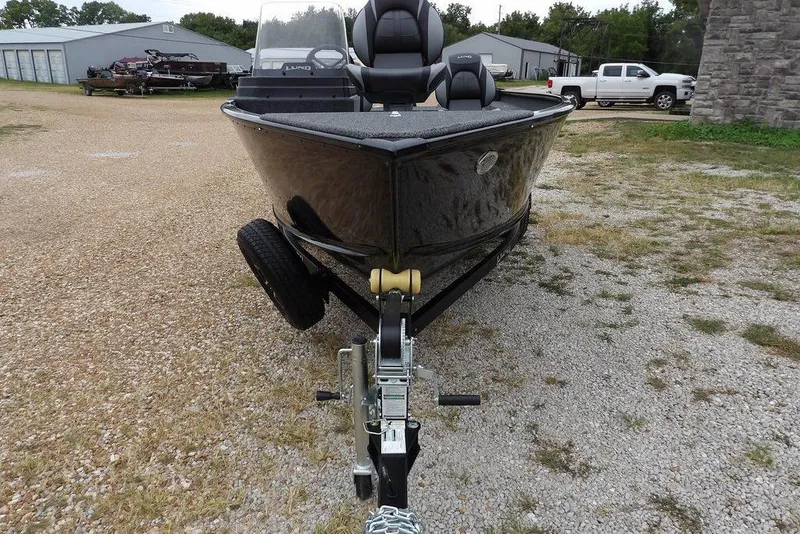 Slide: The Image of 2026 Lund 1775 Adventure SS boat on trailer, parked outdoors on gravel. - 4