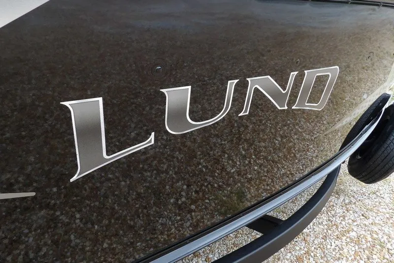 Slide: The Image of 2026 Lund 1775 Adventure SS boat with sleek black exterior and bold logo. - 40