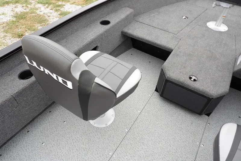 Slide: The Image of 2026 Lund 1775 Adventure SS boat interior with gray seating and carpeted flooring. - 43