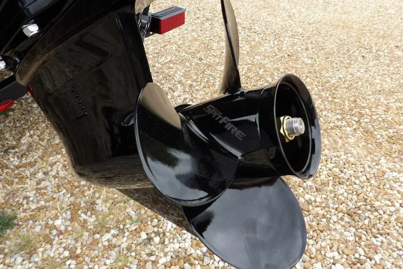 Slide: The Image of 2026 Lund 1775 Adventure SS boat propeller on gravel surface. - 44