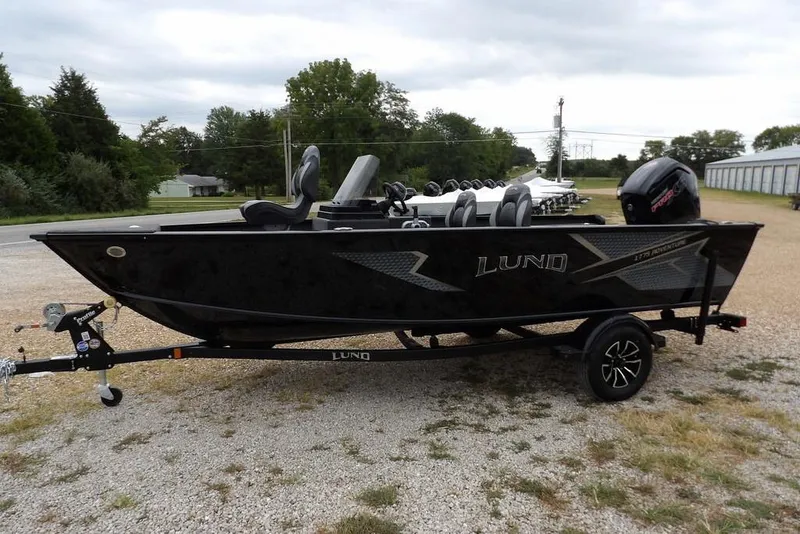 Slide: The Image of 2026 Lund 1775 Adventure SS boat on trailer, parked outdoors. - 6