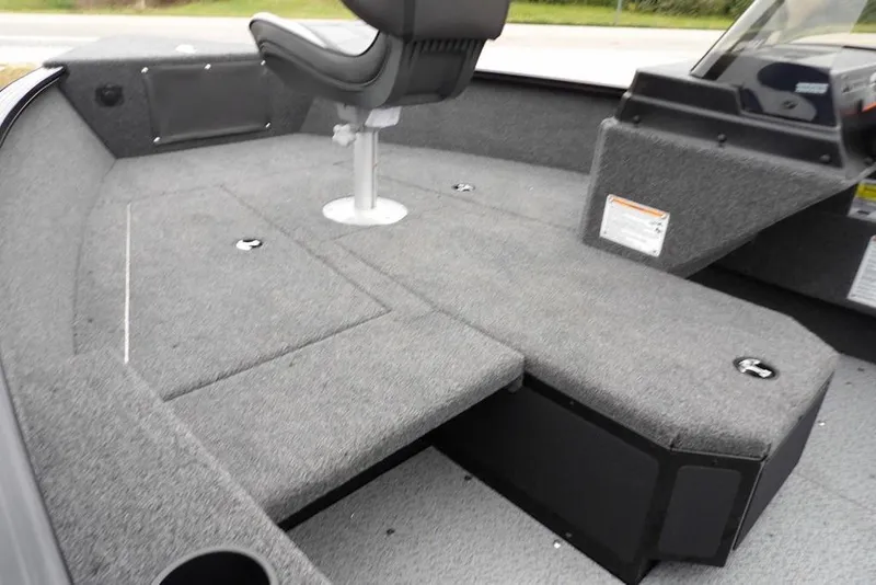 Slide: The Image of 2026 Lund 1775 Adventure SS boat interior with gray carpet and seating. - 9