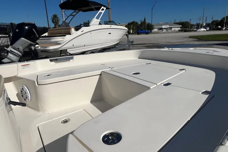 Slide: The Image of 2005 Pathfinder TRS boat interior with seating and storage, parked outdoors, 2022 model. - 6