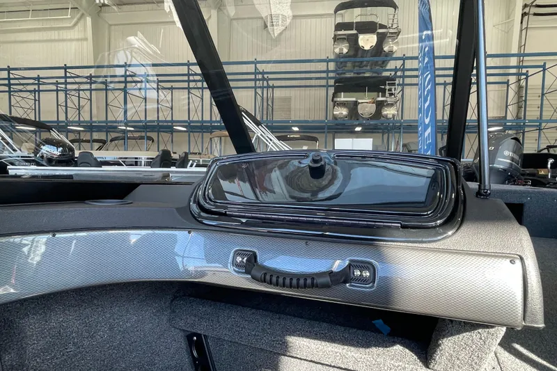 Slide: The Image of 2026 Crestliner 1650 Hawk boat interior with sleek dashboard and storage compartment. - 10