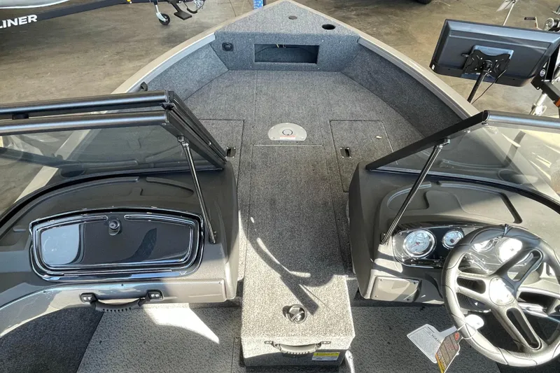 Slide: The Image of 2026 Crestliner 1650 Hawk boat interior with steering wheel and dashboard. - 13