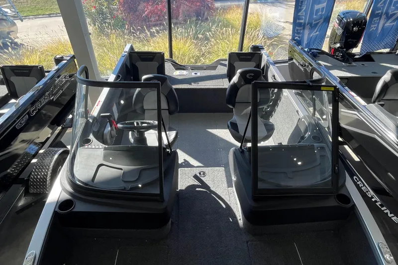 Slide: The Image of 2026 Crestliner 1650 Hawk boat interior with dual consoles and seating. - 17