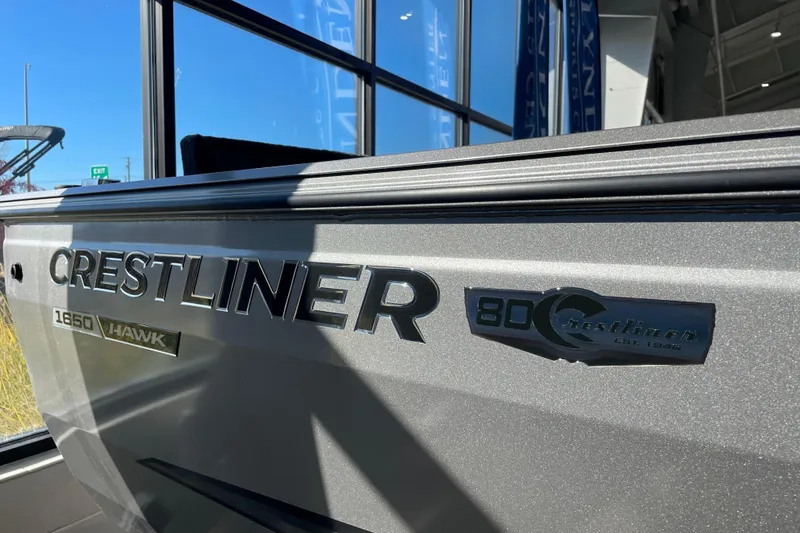 Slide: The Image of 2026 Crestliner 1650 Hawk boat side view with logo and branding details. - 18