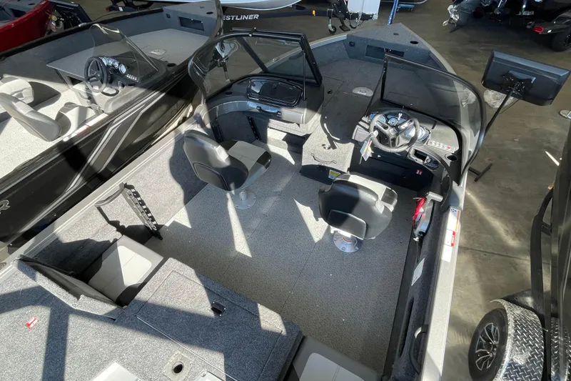 Slide: The Image of 2026 Crestliner 1650 Hawk boat interior with seating and steering console. - 3