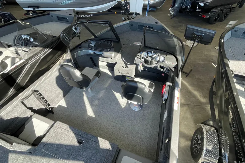 Slide: The Image of 2026 Crestliner 1650 Hawk boat interior with dual seats and modern dashboard. - 4