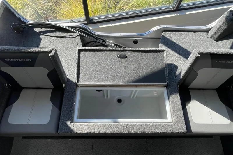 Slide: The Image of 2026 Crestliner 1650 Hawk boat interior with storage compartment and seating. - 5