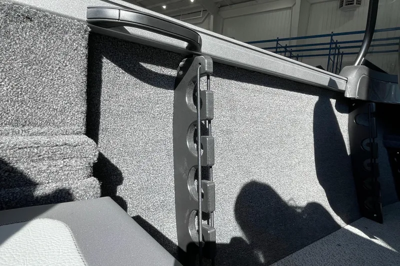 Slide: The Image of 2026 Crestliner 1650 Hawk interior detail with rod holder and carpeted finish. - 7