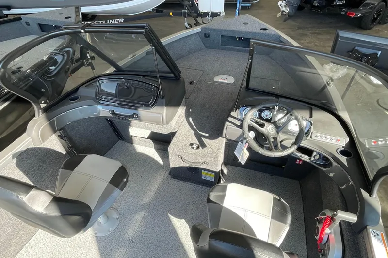 Slide: The Image of 2026 Crestliner 1650 Hawk boat interior with dual seats and steering console. - 8