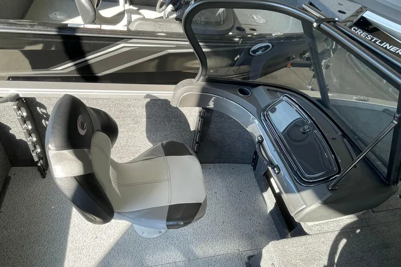 Slide: The Image of 2026 Crestliner 1650 Hawk interior with swivel seat and console, showcasing modern design. - 9